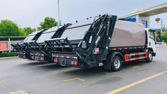 Side view of ISUZU rear compression waste collection truck ready for Iraq delivery