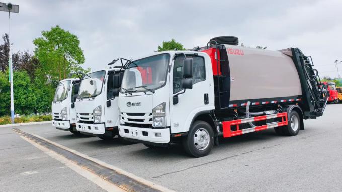 Batch of ISUZU chassis compactor garbage trucks lined up at Chengli factory yard