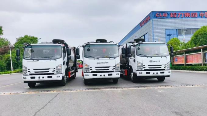 Front view of ISUZU municipal waste compactor trucks ready for export to Iraq